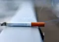 A burning cigarette placed on a handrail